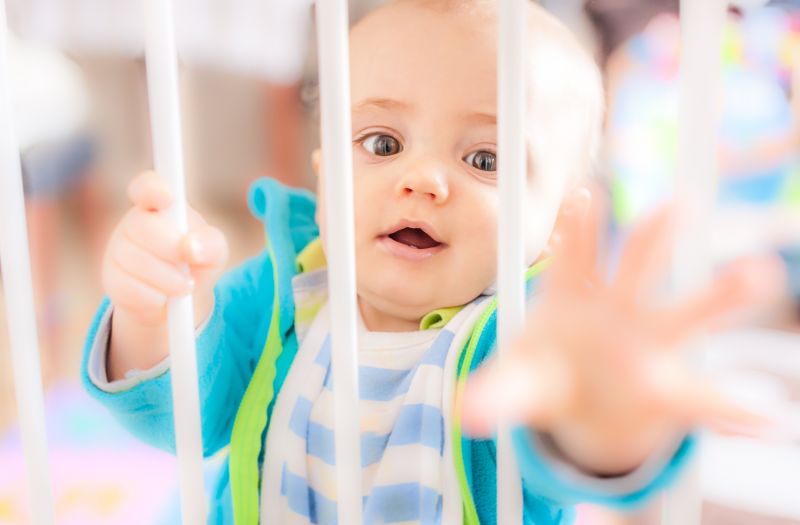 Child Playing Near Mesh Fence